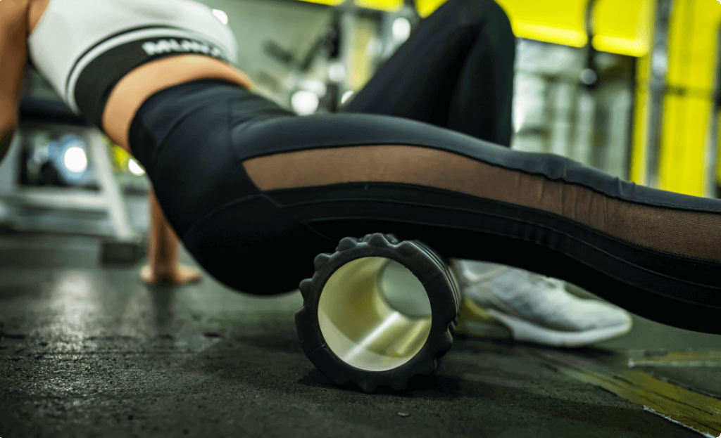 A girl foam rolling after exercise