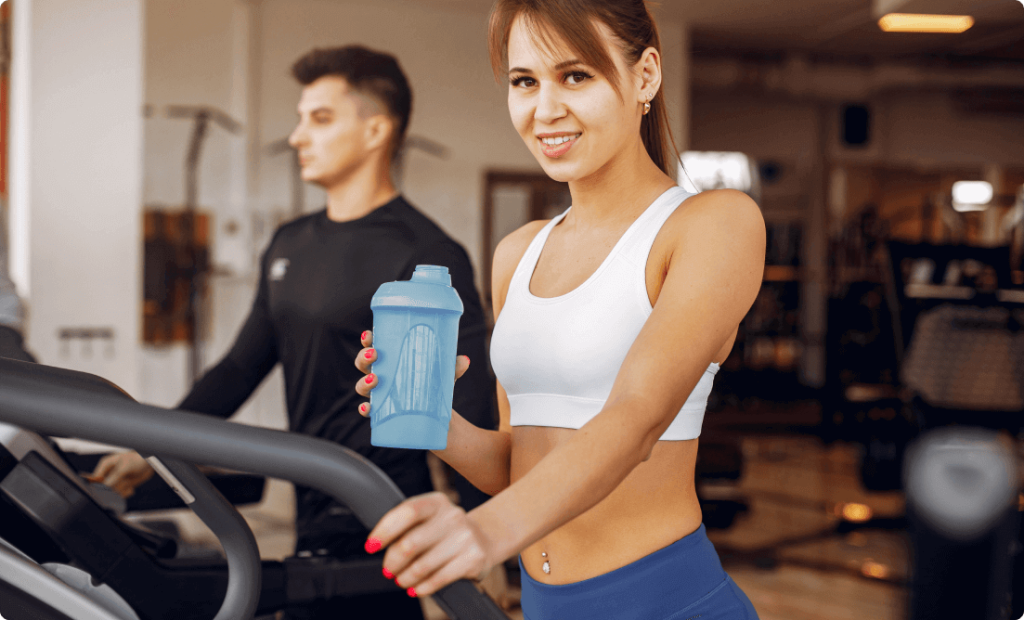 A girl holding a water bottle and exercising to stay hydrated