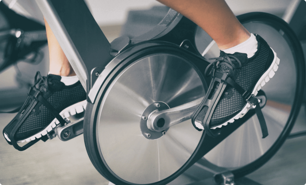 A guy riding an indoor cycle