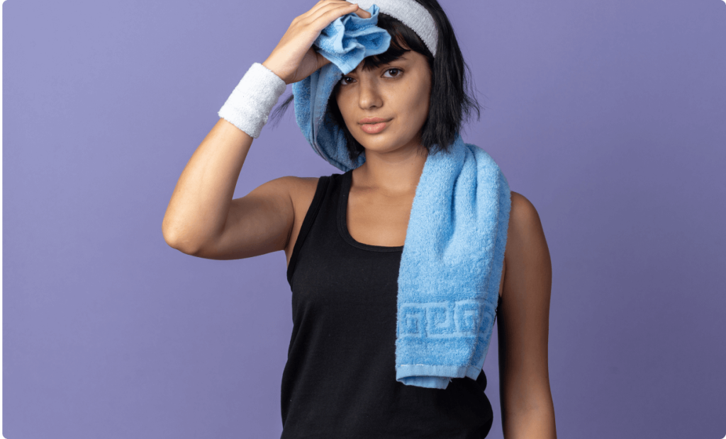 A girl wiping her sweat with a towel