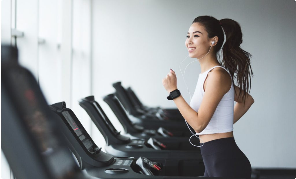 A girl running on treadmill while listening to music at VSC