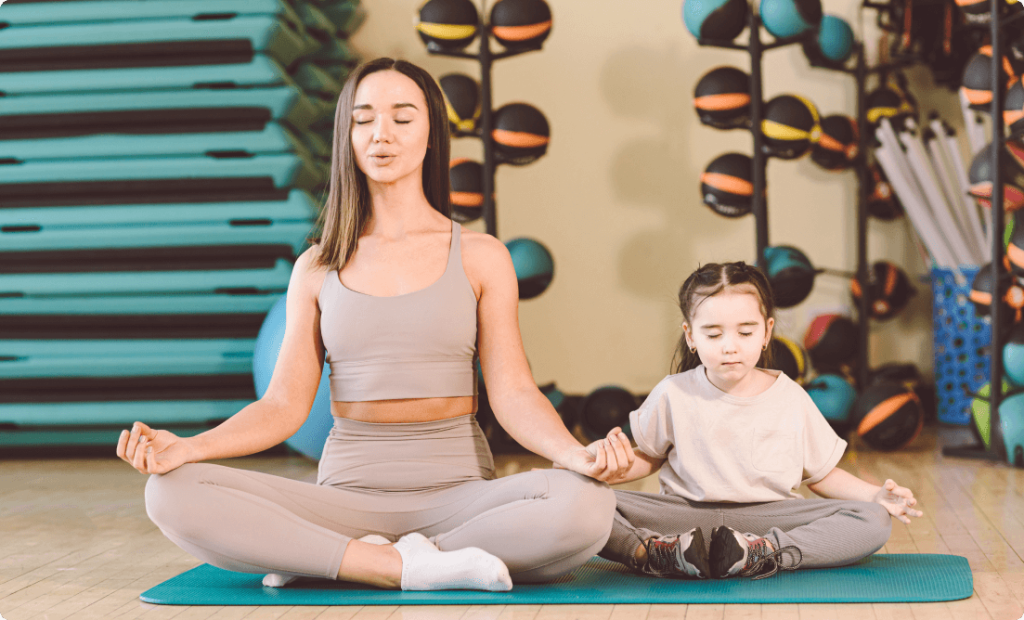 Mother and kid doing yoga together