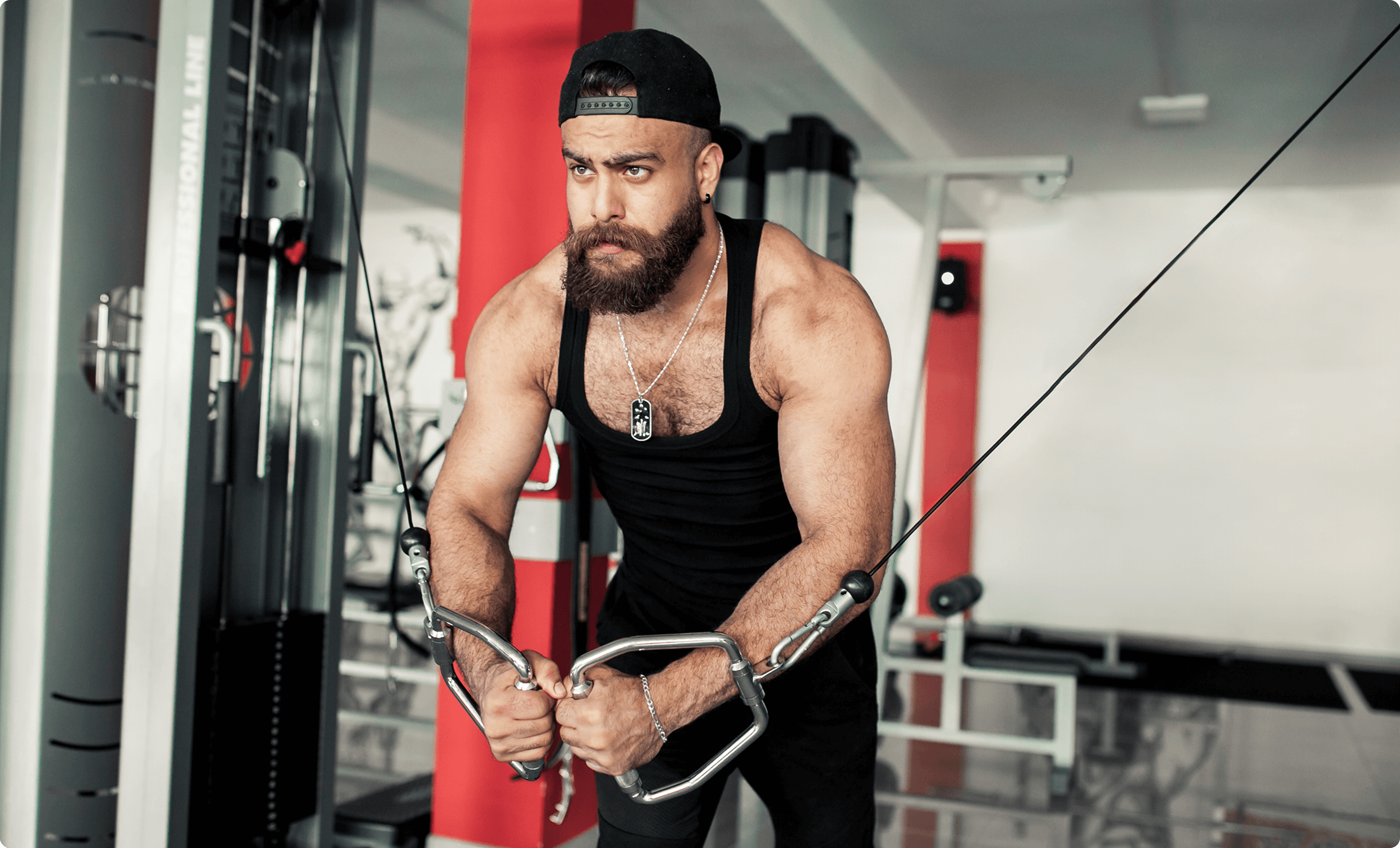A bodybuilder performing a TRX fly exercise, focusing on chest and shoulder strength at Vision Elite Training.