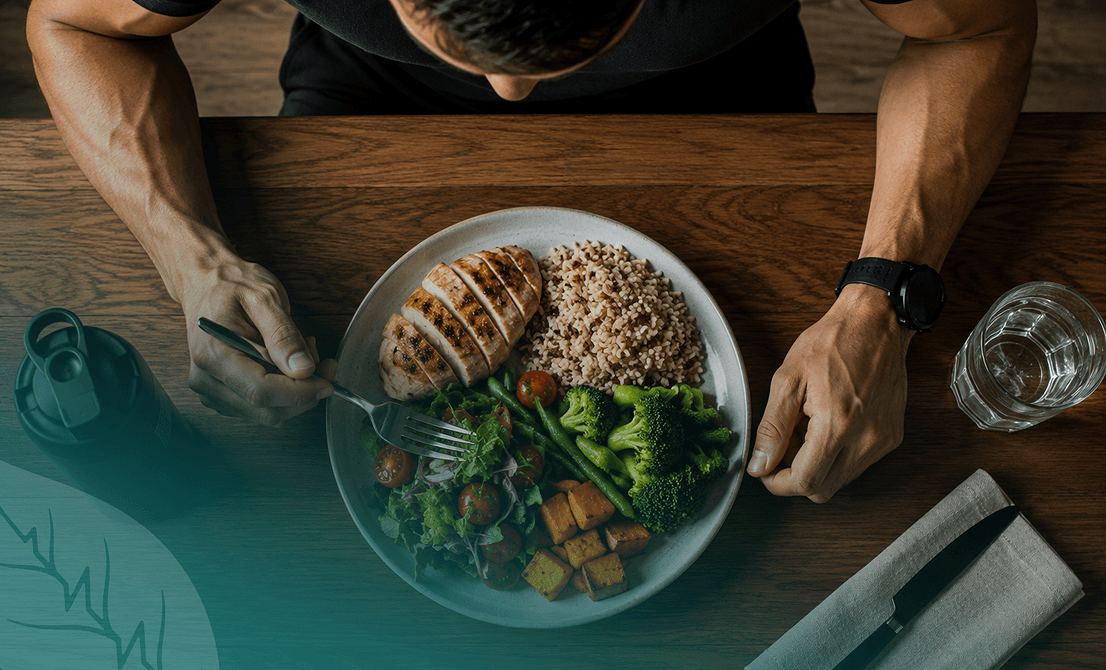 Man eating a balanced meal, reflecting Vision Elite Training’s approach to sustainable nutrition and fitness habits.