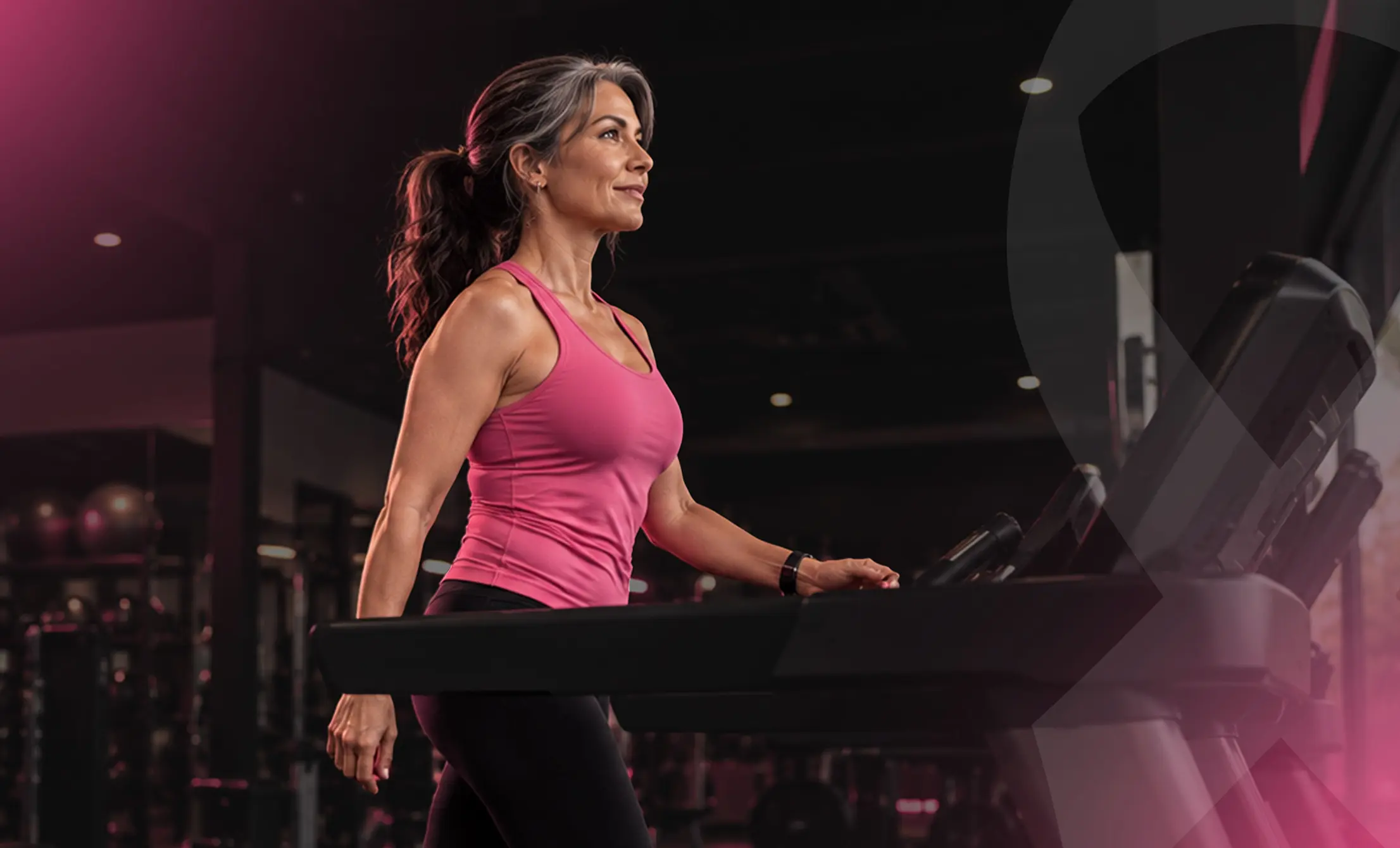 Woman walking on a treadmill during a fitness workout at Vision Elite.