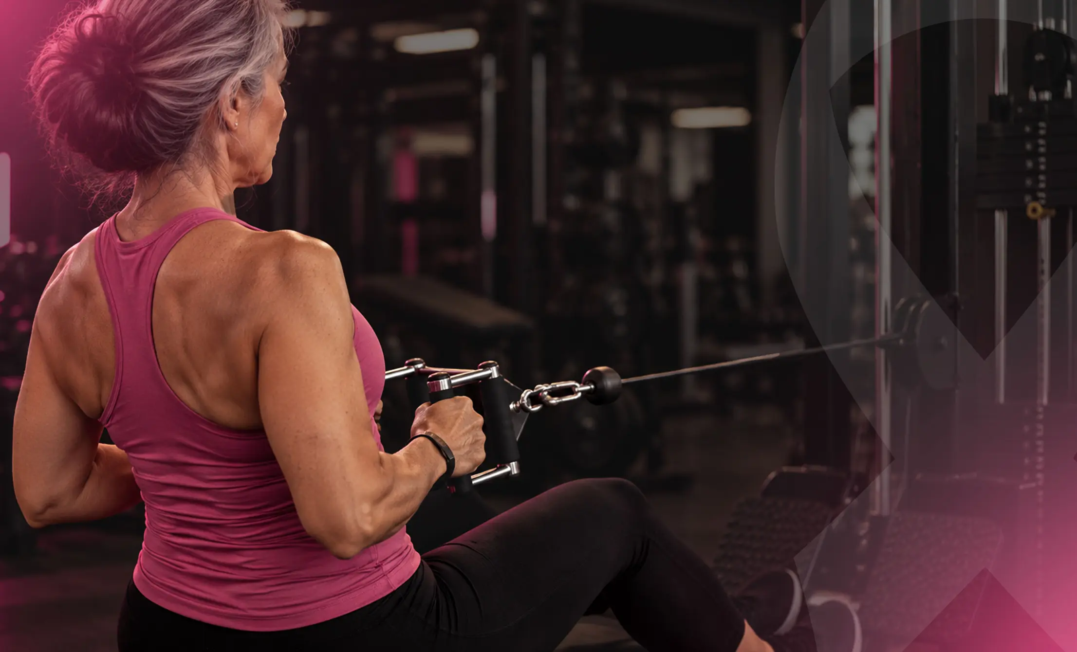 Woman performing seated cable resistance training during breast cancer recovery.