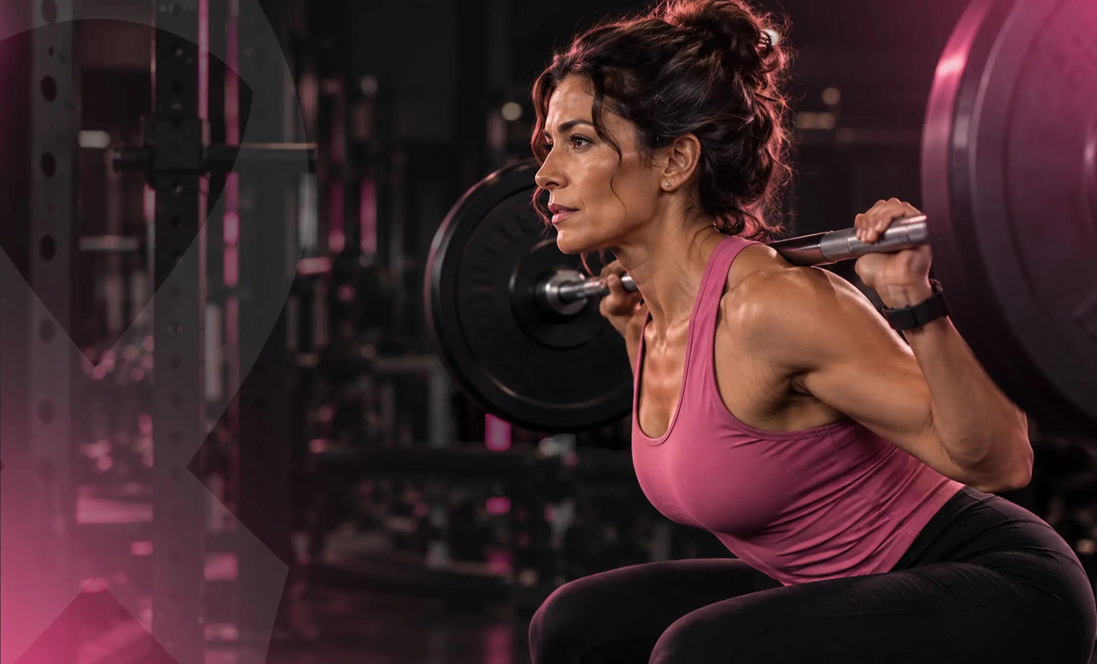 Woman performing a barbell squat during strength training exercise at Vision Elite